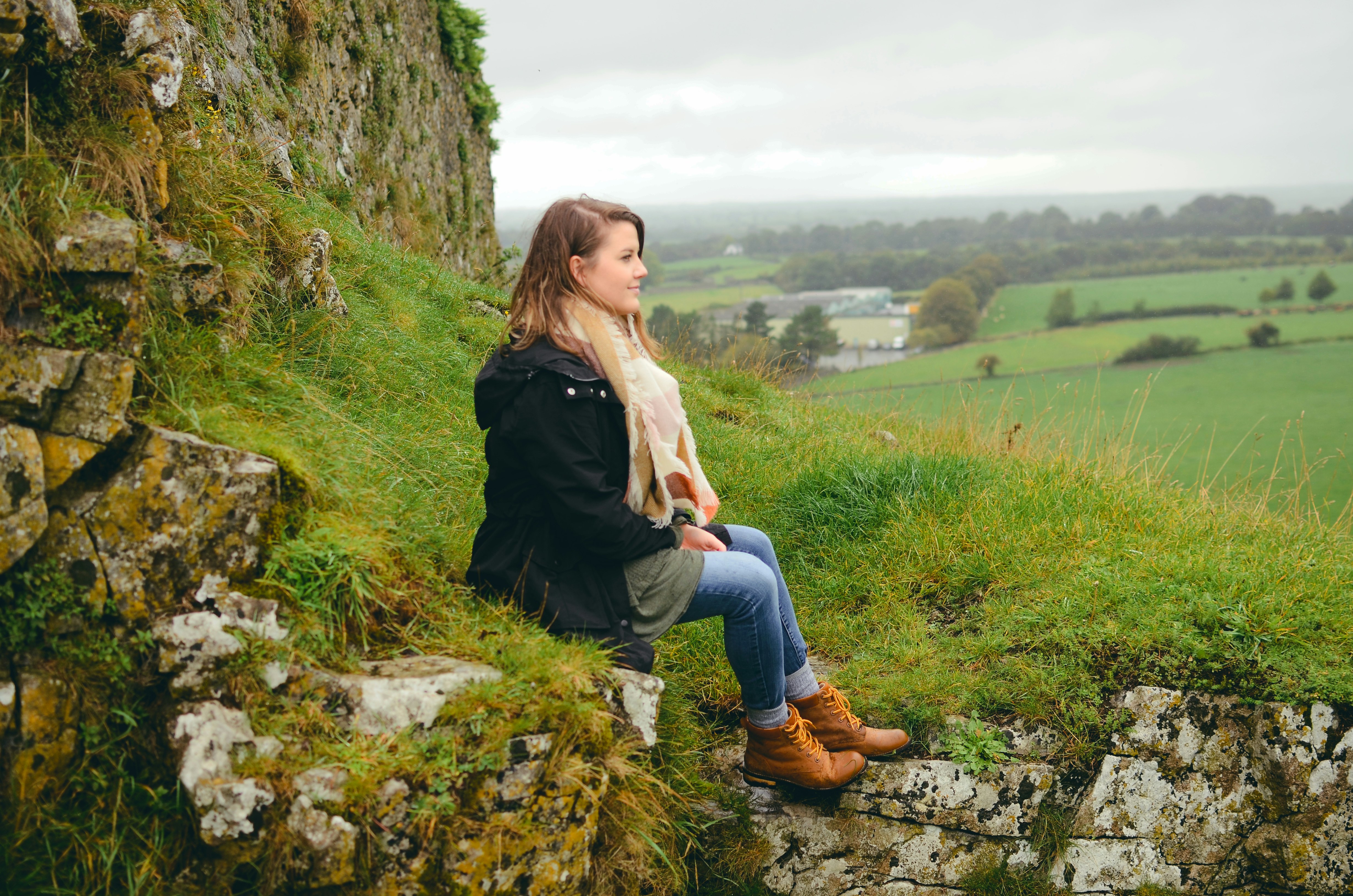 woman sitting on rock